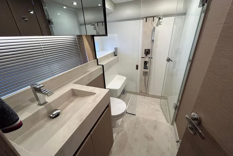  Yacht Photos Pics Luxurious bathroom in 2023 Prestige 590 yacht with modern fixtures and glass shower.
