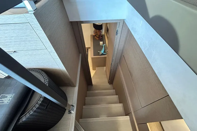  Yacht Photos Pics Interior view of 2023 Prestige 590 yacht, featuring modern wooden stairs and sleek design.