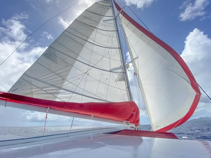 Stella Maris Yacht Photos Pics Sailing on a 2008 Fountaine Pajot Eleuthera 60 catamaran with red and white sails.