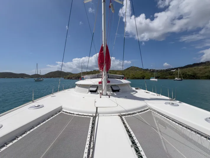 Stella Maris Yacht Photos Pics Fountaine Pajot Eleuthera 60 catamaran on serene water, 2008 model, clear sky, scenic backdrop.