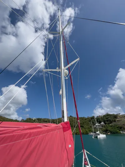 Stella Maris Yacht Photos Pics Sailboat mast of 2008 Fountaine Pajot Eleuthera 60 against blue sky and clouds.