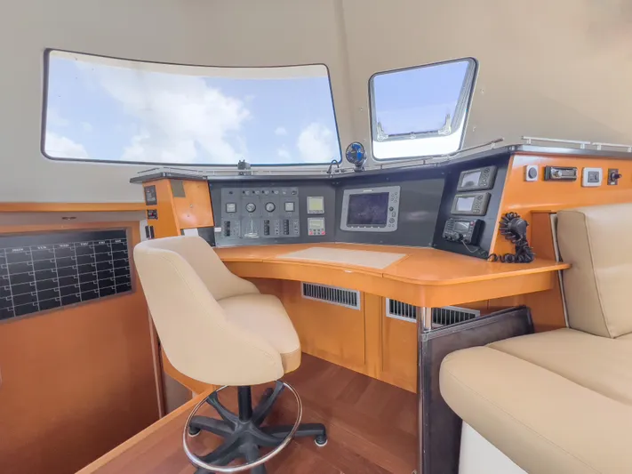 Stella Maris Yacht Photos Pics Helm station of 2008 Fountaine Pajot Eleuthera 60 catamaran with navigation controls and seating.
