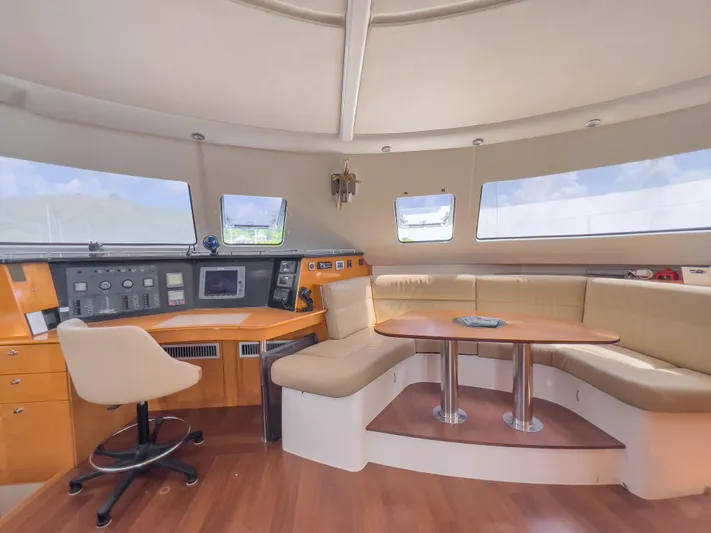 Stella Maris Yacht Photos Pics Interior of 2008 Fountaine Pajot Eleuthera 60 yacht with navigation station and seating area.