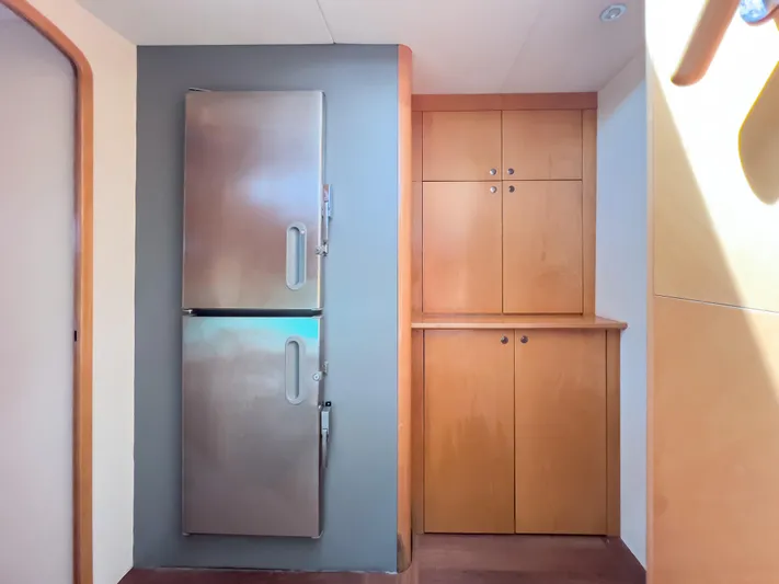 Stella Maris Yacht Photos Pics Interior of 2008 Fountaine Pajot Eleuthera 60 with stainless steel fridge and wooden cabinets.