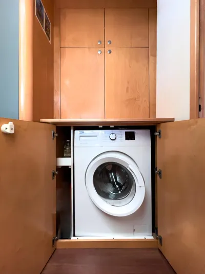 Stella Maris Yacht Photos Pics Washing machine in Fountaine Pajot Eleuthera 60 yacht, 2008 model, with wooden cabinetry.