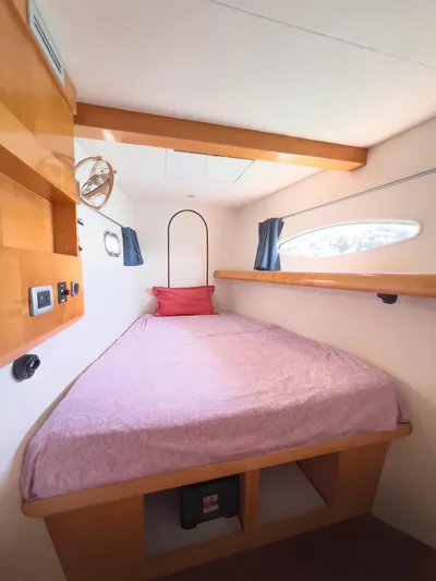 Stella Maris Yacht Photos Pics Cozy cabin interior of 2008 Fountaine Pajot Eleuthera 60 catamaran with bed and porthole.