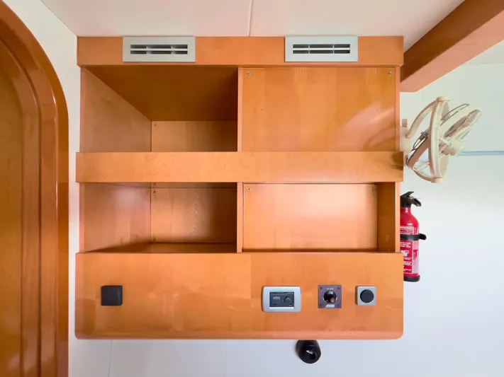 Stella Maris Yacht Photos Pics Wooden storage unit with controls and fan on a 2008 Fountaine Pajot Eleuthera 60 yacht.