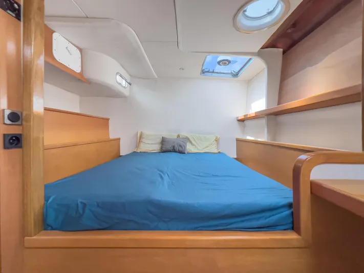 Stella Maris Yacht Photos Pics Cabin interior of 2008 Fountaine Pajot Eleuthera 60 with blue bedding and wooden accents.