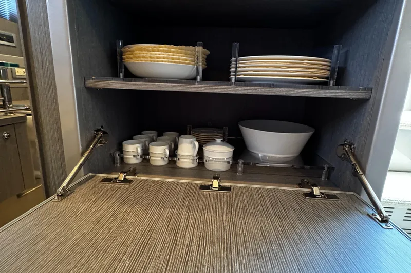 Sea Sea Yacht Photos Pics Cabinet with neatly arranged dishes and cups inside a 2013 Riva Rivarama Super yacht.