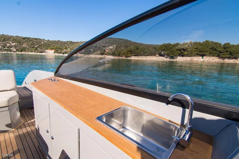  Yacht Photos Pics Luxury boat Rand Supreme 27, 2025 model, featuring a sleek outdoor sink and scenic water view.