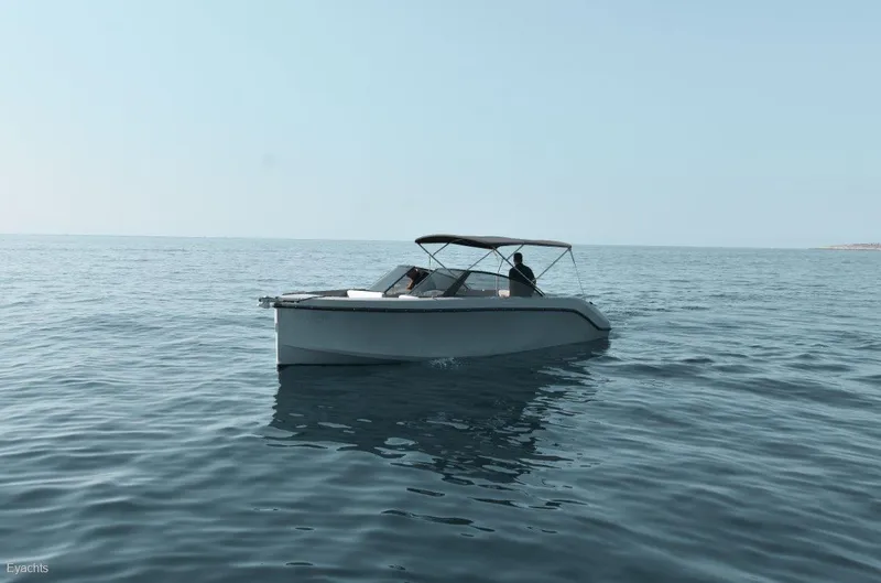  Yacht Photos Pics 2025 Rand Supreme 27 boat cruising on calm ocean waters.