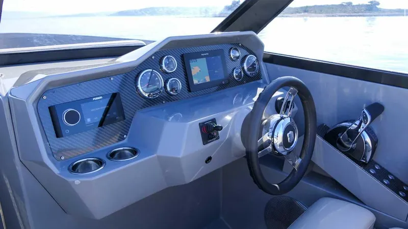 Yacht Photos Pics Cockpit of 2025 Rand Supreme 27 boat with modern dashboard and steering wheel.
