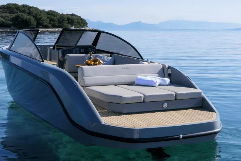  Yacht Photos Pics Luxurious 2025 Rand Supreme 27 boat on serene water, featuring sleek design and comfortable seating.