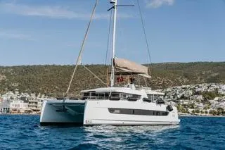  Yacht Photos Pics 2022 Bali 4.6 Open Space catamaran sailing on blue waters near a coastal landscape.