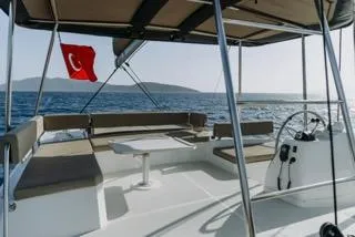  Yacht Photos Pics 2022 Bali 4.6 Open Space catamaran with Turkish flag, ocean view, and spacious seating area.
