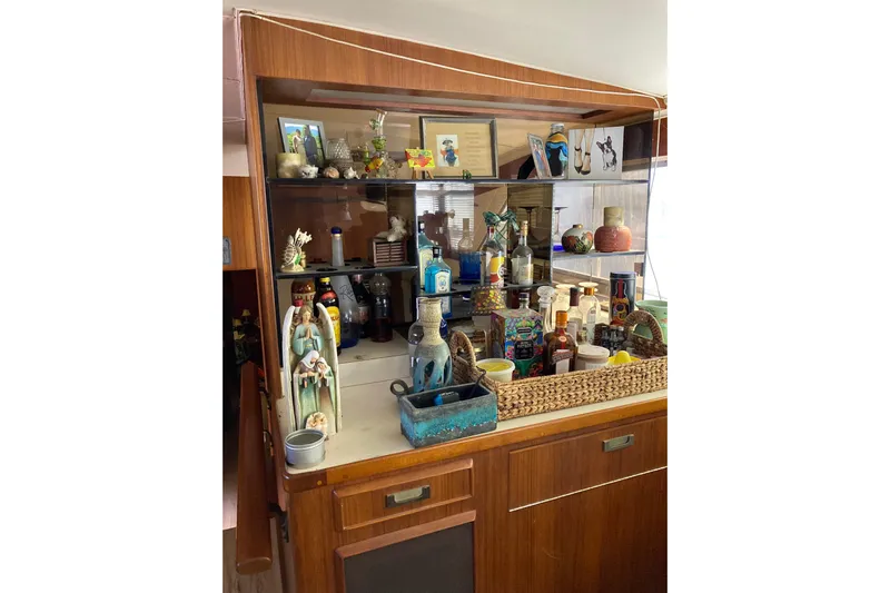 Lamb Chop Yacht Photos Pics Interior of 1985 Bertram 58 Flybridge Motor Yacht with decorative items and bottles.