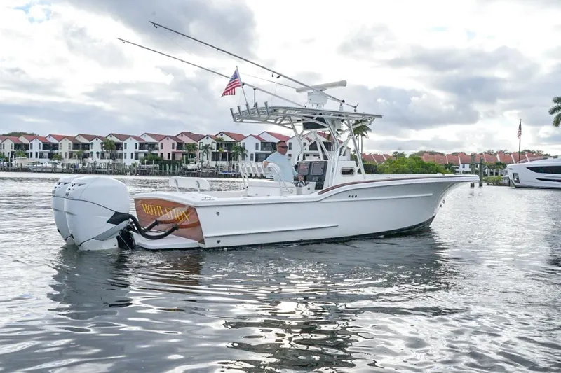  Yacht Photos Pics 2008 Buddy Davis 28 Center Console boat on water, with American flag, near waterfront homes.