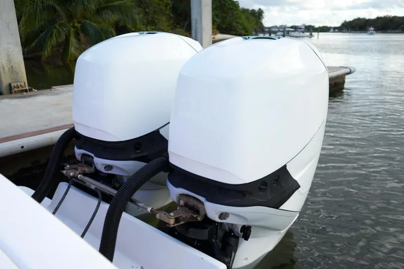  Yacht Photos Pics Twin outboard engines on a 2008 Buddy Davis 28 Center Console boat docked by water.