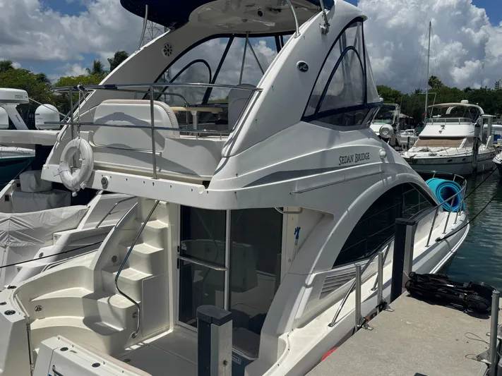  Yacht Photos Pics 2007 Sea Ray 360 Sedan yacht docked at marina under cloudy sky.
