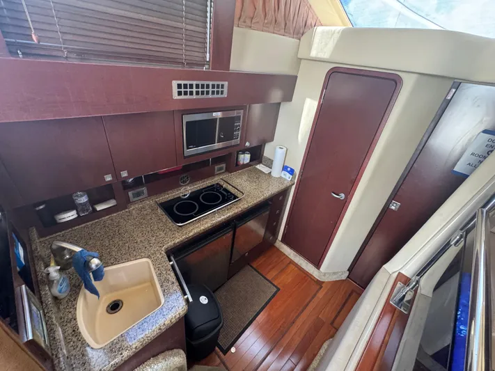  Yacht Photos Pics Interior of 2007 Sea Ray 360 Sedan yacht kitchen with modern amenities and wood flooring.