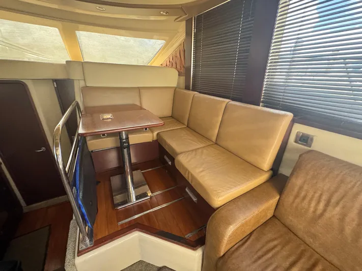  Yacht Photos Pics Interior of 2007 Sea Ray 360 Sedan with beige seating and wooden table.
