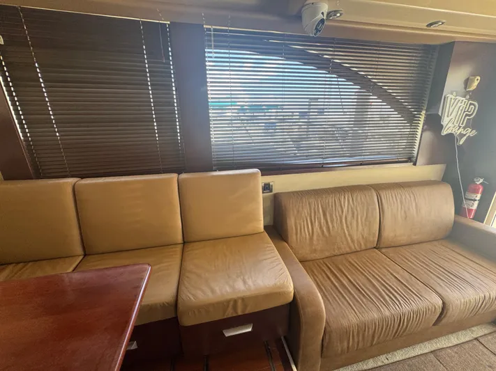  Yacht Photos Pics Luxurious interior of 2007 Sea Ray 360 Sedan with beige seating and wooden table.