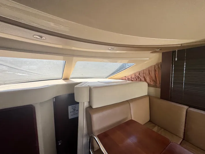  Yacht Photos Pics Interior of 2007 Sea Ray 360 Sedan with beige seating and wooden table.