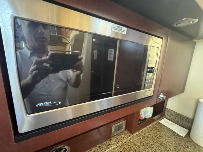  Yacht Photos Pics Microwave in 2007 Sea Ray 360 Sedan kitchen with granite countertop and wooden cabinetry.