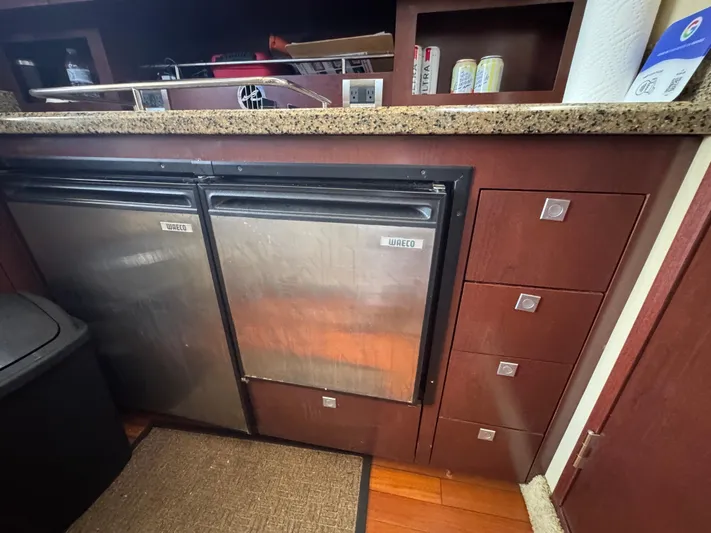  Yacht Photos Pics Interior of 2007 Sea Ray 360 Sedan with compact kitchen appliances and wooden cabinetry.