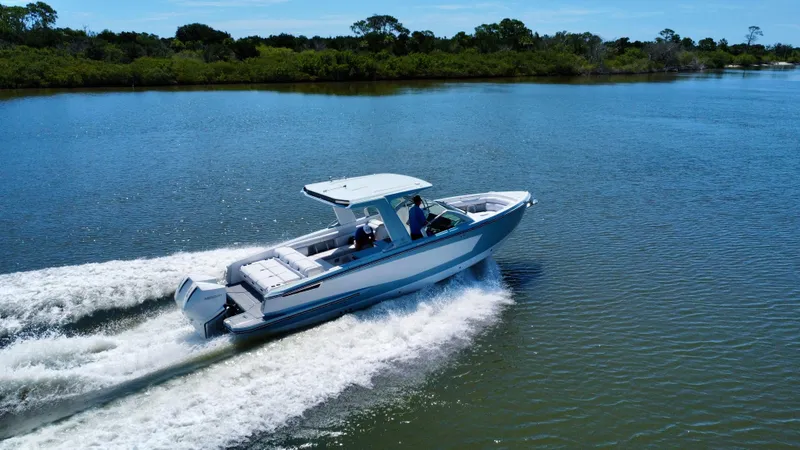  Yacht Photos Pics 2021 Aviara AV32 OB boat cruising on a serene lake.