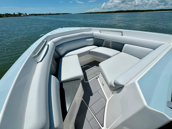  Yacht Photos Pics 2021 Aviara AV32 OB boat with spacious seating on a serene water backdrop.