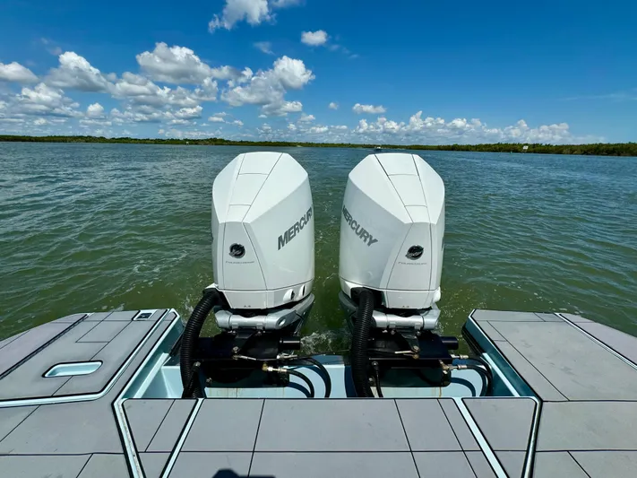  Yacht Photos Pics 2021 Aviara AV32 OB with twin Mercury outboard engines on a calm lake.