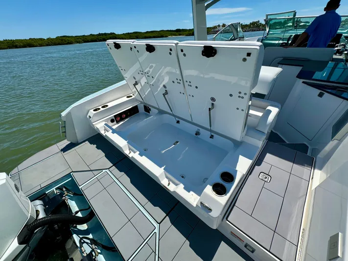  Yacht Photos Pics 2021 Aviara AV32 OB boat with open storage compartment on a sunny day.