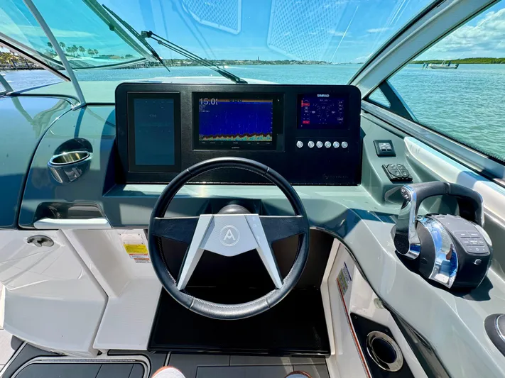  Yacht Photos Pics 2021 Aviara AV32 OB boat cockpit with modern steering wheel and digital displays.