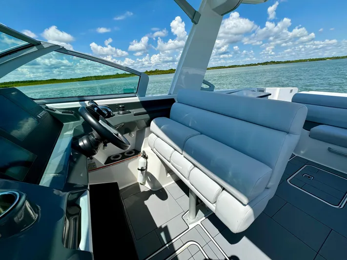  Yacht Photos Pics 2021 Aviara AV32 OB boat interior with white seating and scenic water view.
