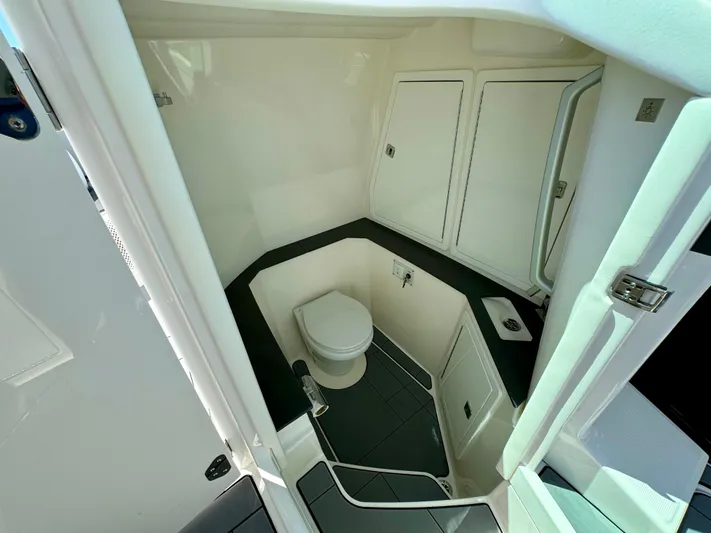  Yacht Photos Pics 2021 Aviara AV32 OB boat interior bathroom with toilet and storage cabinets.