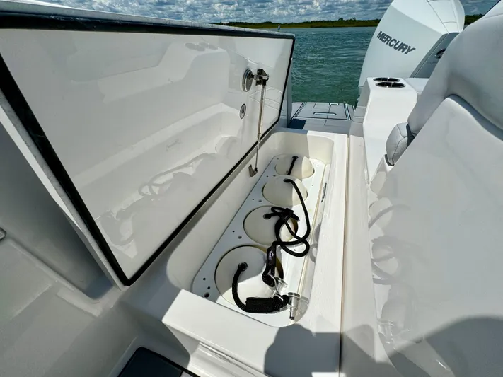  Yacht Photos Pics 2021 Aviara AV32 OB boat storage compartment with open lid, showing cables and equipment.