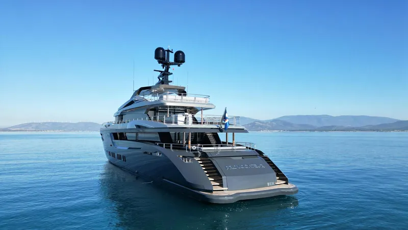 Provocateur Yacht Photos Pics Luxurious 2016 Mondomarine 50-meter yacht on serene blue waters, with distant mountains.