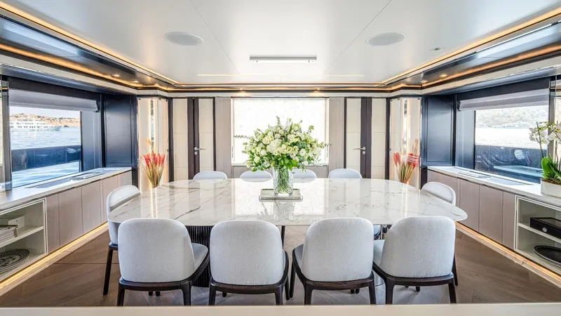 Provocateur Yacht Photos Pics Luxurious dining area on 2016 Mondomarine 50 Meters yacht with elegant decor and large windows.