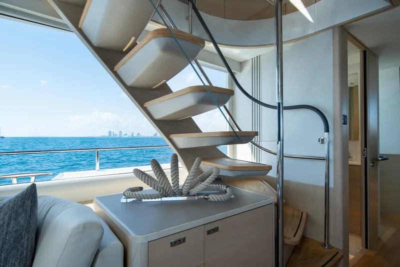 Maravi Yacht Photos Pics Luxurious interior of 2025 Princess X80 yacht with modern staircase and ocean view.