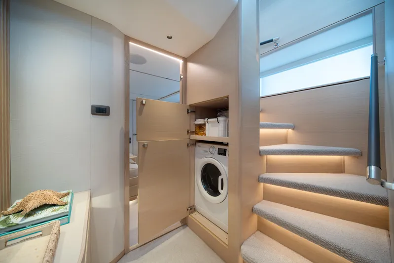 Maravi Yacht Photos Pics Modern interior of 2025 Princess X80 yacht with washing machine and elegant staircase.