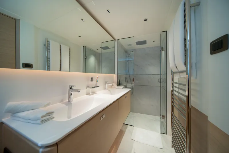 Maravi Yacht Photos Pics Luxurious bathroom in 2025 Princess X80 yacht with modern fixtures and glass shower.