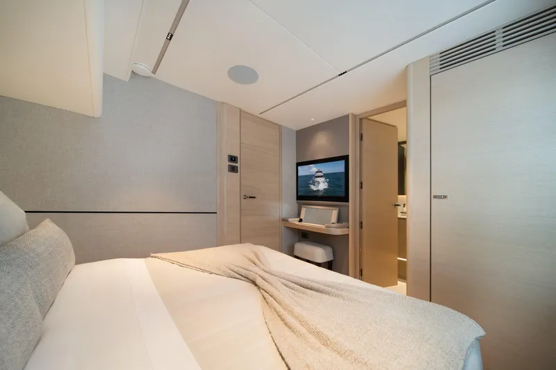 Maravi Yacht Photos Pics Luxurious bedroom interior of 2025 Princess X80 yacht with modern decor and TV.