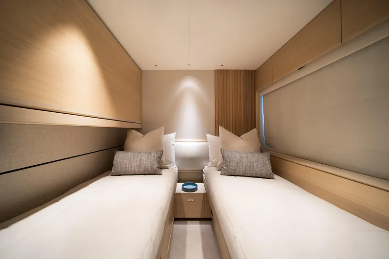 Maravi Yacht Photos Pics Luxurious twin cabin interior of 2025 Princess X80 yacht, featuring modern design and cozy bedding.