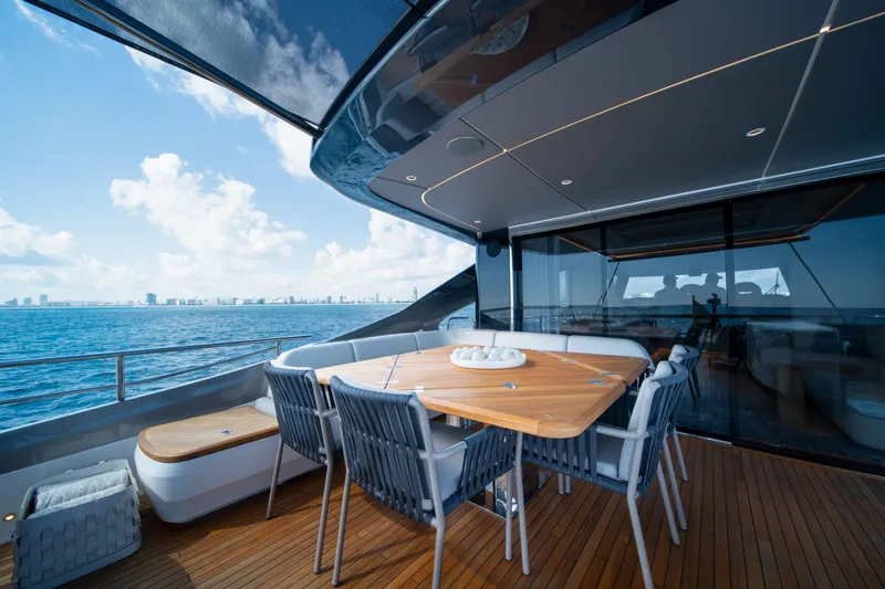 Maravi Yacht Photos Pics Luxurious 2025 Princess X80 yacht deck with elegant dining area and ocean view.