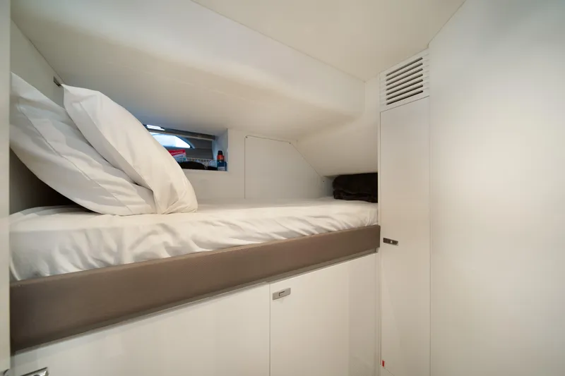 Maravi Yacht Photos Pics Cozy cabin bed in 2025 Princess X80 yacht, featuring sleek white interior design.