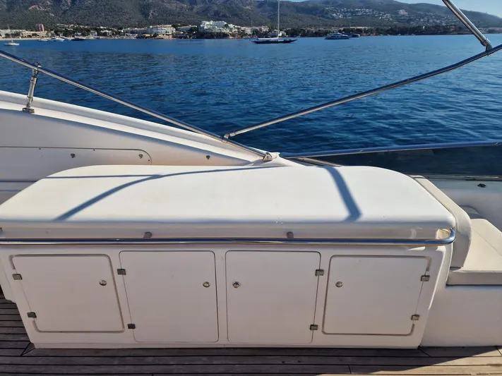  Yacht Photos Pics Astondoa 82 GLX 2000 yacht deck with storage compartments, overlooking serene waters.
