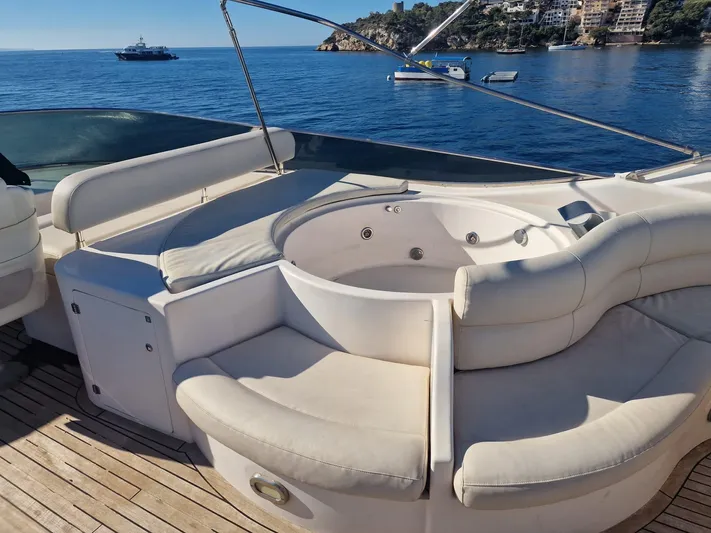  Yacht Photos Pics Luxurious Astondoa 82 GLX yacht deck with jacuzzi, overlooking serene ocean view.