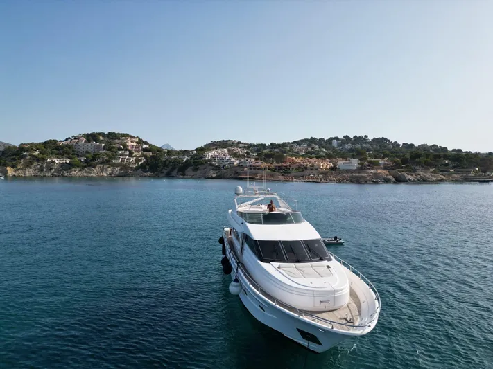  Yacht Photos Pics Luxury Astondoa 82 GLX yacht from 2000 on serene blue waters near scenic coastline.