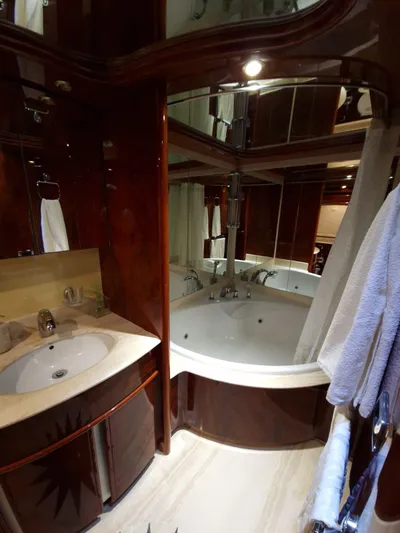  Yacht Photos Pics Luxurious bathroom in 2000 Astondoa 82 GLX yacht with elegant wood finishes.